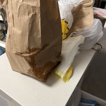 Tacos & Co - Paper bag with the 2 servings of flan that tipped & leaked the caramel sauce. - Mexican Near Me - Ladera Ranch, California Tacos & Co - Paper bag with the 2 servings of flan that tipped & leaked the caramel sauce. - Mexican Near Me - Ladera Ranch, California
