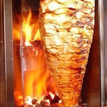 Shawarma Day - a large meat roasting on a spiter - Mediterranean Near Me - Toronto, Ontario