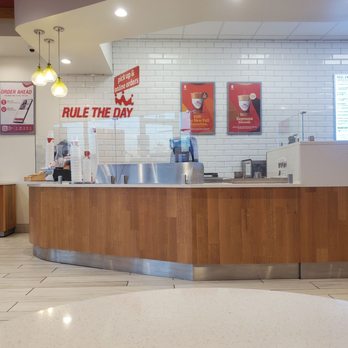 Smoothie King - a counter with a roll the day sign on it - Juice Bars & Smoothies Near Me - Odessa, Texas