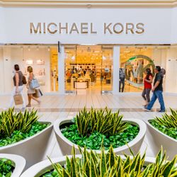 Fashion Outlets of Niagara Falls USA - Shoppers walk past the Michael Kors storefront at Fashion Outlets of Niagara Falls USA.