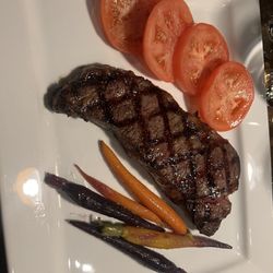 Serafina's Steakhouse - NY strip, seasonal veggies and sliced tomatoes.