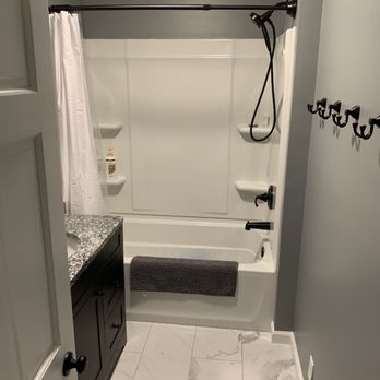 Meyer Renovation - a bathroom with a shower, tub, and sink - Flooring Near Me - Ossian, Indiana