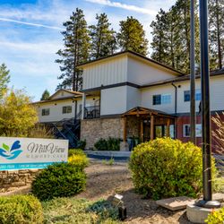 Mill View Memory Care - Mill View Memory Care in Bend, Oregon: A serene facility surrounded by lush landscaping, tall pines, and a warm, inviting atmosphere.
