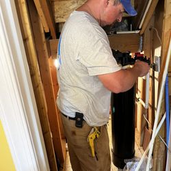 All Water Filtration And Well Services - Installing a filtration system under a stairwell