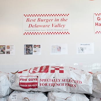 Five Guys - a large pile of bags of food - Burgers Near Me - Twin Falls, Idaho Five Guys - a large pile of bags of food - Burgers Near Me - Twin Falls, Idaho