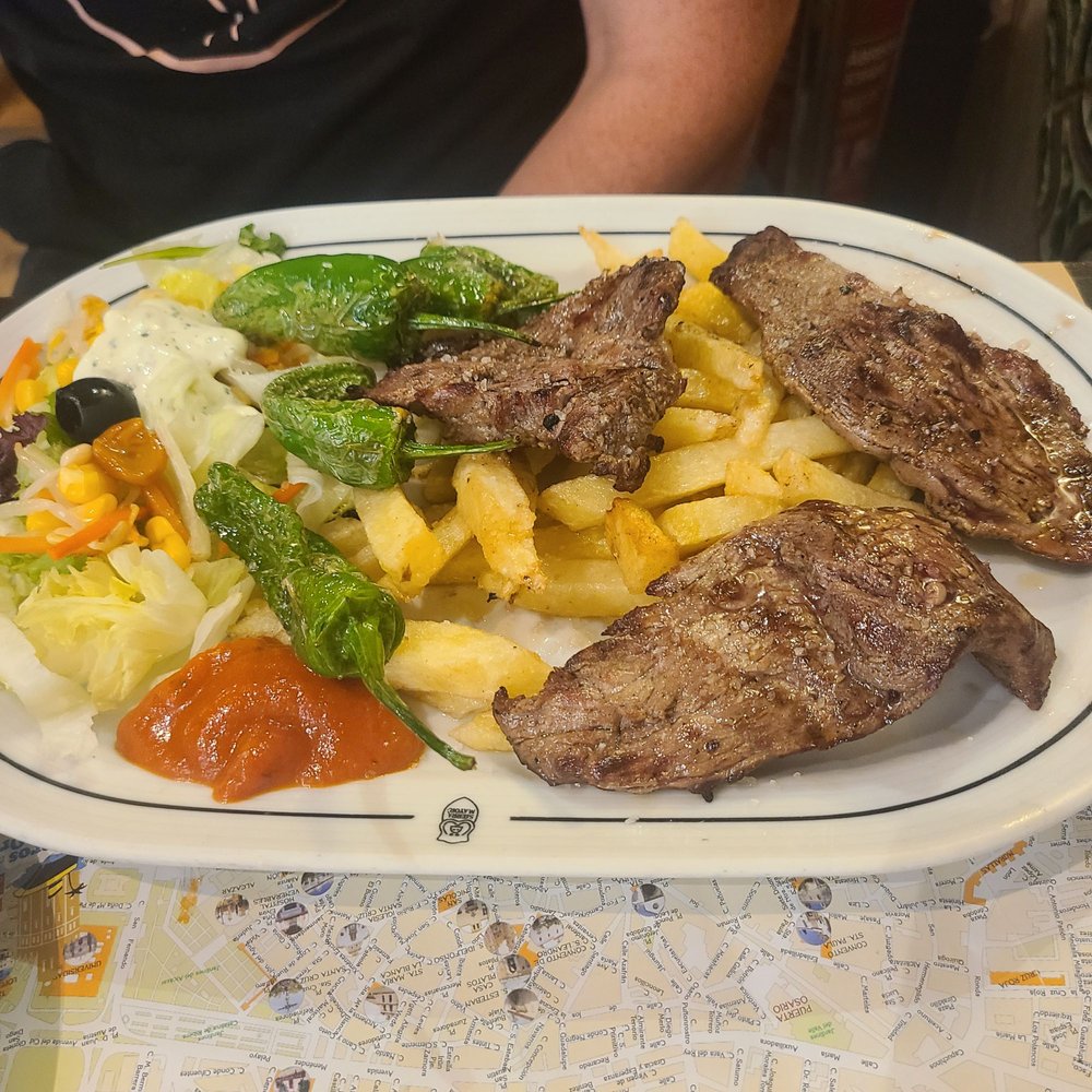 La Tradicional - Imperial sirloin platter 14$ came with fries and salad and peppers. Yummy yummy beef was well done even though we order rare - Tapas Bars Near Me - Seville, SE