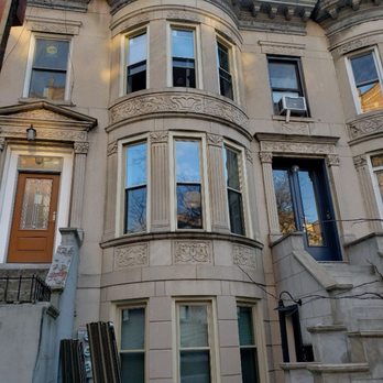 Unbeatable Repairs - Exterior picture after installation. Replaced dark bronze aluminum windows with R5.5 Tan UPvc windows - Windows Installation Near Me - Staten Island, New York