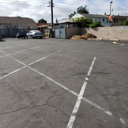 Dollar Tree - Trash piled up, pallets, homeless Male living still in rear of trash enclosure. The urine smell is horrible