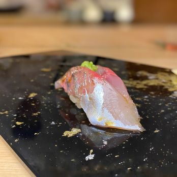 Tsubame - a piece of sushi on a black plate - Japanese Near Me - New York, New York Tsubame - a piece of sushi on a black plate - Japanese Near Me - New York, New York