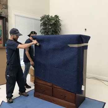 Mighty Movers - Wrapping dresser with moving blankets and shrinkwrap - Movers Near Me - Herndon, Virginia