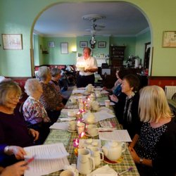 Hamiltons Tea Rooms - John bringing in the delicious cake that Noel crafted for our birthday girl