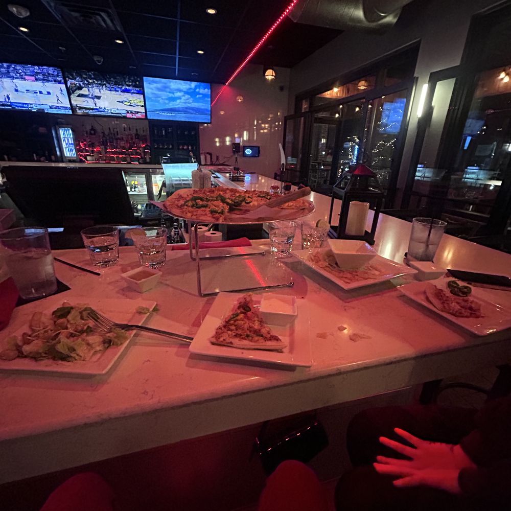 The Rooftop - a long table with plates of food on it - Pizza Near Me - Broken Arrow, Oklahoma