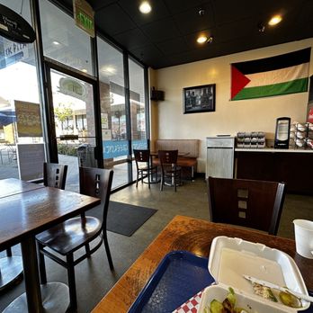 Greek Pita - Inside looking out. Half seats close to front door. - Greek Near Me - Bellevue, Washington