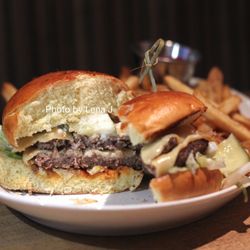 Banff Social - Alberta Bison Burger ($29) - Merlot caramelized onions, tomato mustard jam, smoked aged gouda, house made pickles, brioche bun
