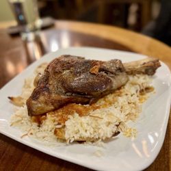Fava Pot - Lamb Fattah Bowl Braised lamb shank, short-grain Egyptian rice, and crispy pita bread