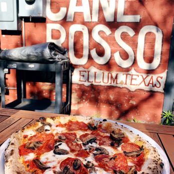 Cane Rosso - a pizza on a plate on a table - Pizza Near Me - Dallas, Texas