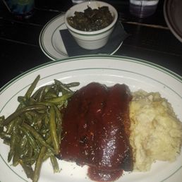 Meatloaf, mashed potatoes, green beans, and collard greens.