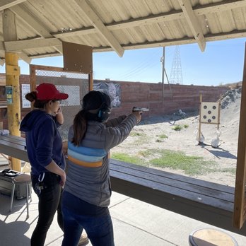 Spectrolite Training - Kelly closely observing the different ways we shoot and giving constructive feedback - from grip to stance to trigger placement. - Firearm Training Near Me Spectrolite Training - Kelly closely observing the different ways we shoot and giving constructive feedback - from grip to stance to trigger placement. - Firearm Training Near Me