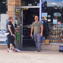 Blue Cave Smoke Shop - The one in the black. Plus they're store smells lime cigarettes because they smoke right next to their open door. Gross...