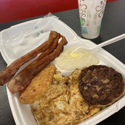 Cajun Corner Cafe - Eggs, grits, bacon, sausage and a hash brown.