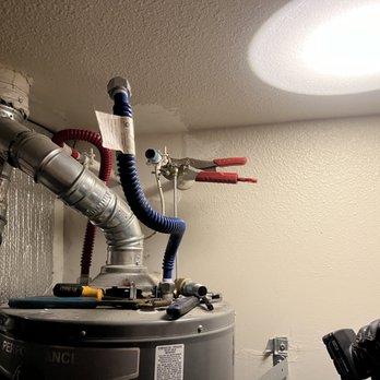 Iman Plumbing Services - Working on water heater shut off valve - Plumbing Near Me Iman Plumbing Services - Working on water heater shut off valve - Plumbing Near Me
