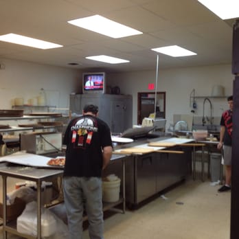 Arnie's Pizza - a man preparing pizza in a commercial kitchen - Pizza Near Me - Warrenville, Illinois Arnie's Pizza - a man preparing pizza in a commercial kitchen - Pizza Near Me - Warrenville, Illinois