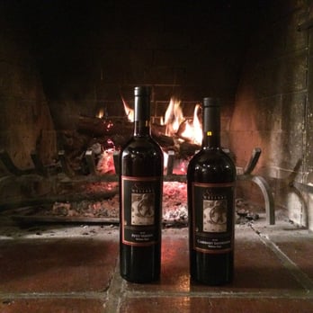 Stina's Cellars - two bottles of wine in front of a fireplace - Beer, Wine & Spirits Near Me - Lakewood, Washington Stina's Cellars - two bottles of wine in front of a fireplace - Beer, Wine & Spirits Near Me - Lakewood, Washington