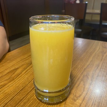 Denny's Restaurant Fleetwood - a glass of orange juice on a table - Breakfast & Brunch Near Me - Surrey, British Columbia