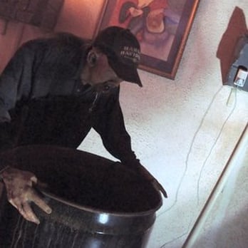 Ghost Outpost - Hillbilly vomiting into garbage can - Haunted Houses Near Me - Wisconsin Dells, Wisconsin