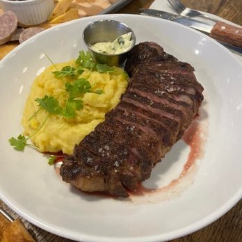 Firestone's - NY strip with manchego cheese mashed potatoes and rosemary-herb butter - New American Near Me - Erie, Pennsylvania Firestone's - NY strip with manchego cheese mashed potatoes and rosemary-herb butter - New American Near Me - Erie, Pennsylvania
