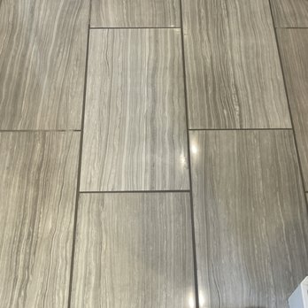 Premier Tile Masters - Tile area repaired due to a bad install by the original builder.  They did a great job matching grout and the install looks flawless. - Flooring Near Me