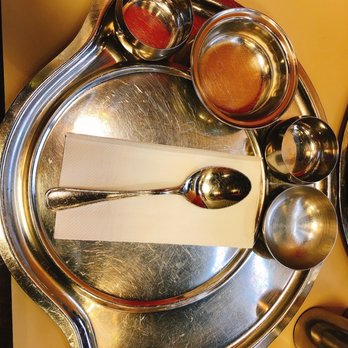 Rajdhani Thali Restaurant - a silver plate with spoons and spoons - Indian Near Me - Issaquah, Washington