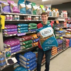 Young's General Store - Zach holding our most popular food: NutriSource Chicken & Rice, 5-Star Rated by DogFoodAdvisor!