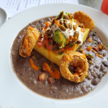 Veganized - "Mex I Can" features Polenta, black beans (pois), onion rings, guacamole, pumpkin seeds and some type of delish frothy creamy like topping. - Vegan Near Me - New Brunswick, New Jersey