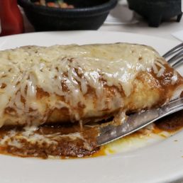 This is the burrito de pollo (mojado). Contains chicken, beans, rice, and vegetables. Cheese and enchilada sauce on the outside. This is the burrito de pollo (mojado). Contains chicken, beans, rice, and vegetables. Cheese and enchilada sauce on the outside.