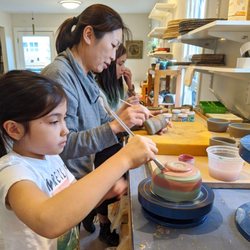 Yu Tang Ceramics - Students glaze their work in a private class.