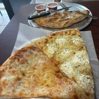 Jerry's Pizza and Subs - White pizza and cheese pizza slices and a calzone with tomato sauce to dip. - Pizza Near Me - Altamonte Springs, Florida Jerry's Pizza and Subs - White pizza and cheese pizza slices and a calzone with tomato sauce to dip. - Pizza Near Me - Altamonte Springs, Florida