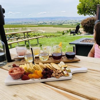 Ste. Chapelle Winery - a little girl sitting at a table with wine and cheese - Wineries Near Me - Caldwell, Idaho Ste. Chapelle Winery - a little girl sitting at a table with wine and cheese - Wineries Near Me - Caldwell, Idaho