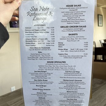 The Sea Note Lounge - a person holding a menu - Sports Bars Near Me - Yachats, Oregon The Sea Note Lounge - a person holding a menu - Sports Bars Near Me - Yachats, Oregon