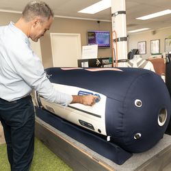 Peters Chiropractic - Dr. Peters setting controls on Hyperbaric Oxygen Chamber.