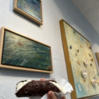 Cafe Dal Mare - a hand holding a chocolate doughnut - Coffee & Tea Near Me - Carmel-by-the-Sea, California