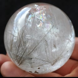 Cosmic Shanti - Colors of the rainbow combined with the rutiles in this quartz sphere tell many fascinating stories and encourage insightful intuition.