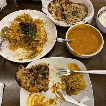 Khaao Macha - We asked for garlic naan to be extra crispy (and it was perfect) so don't get caught up with the char. - Indian Near Me - Akron, Ohio