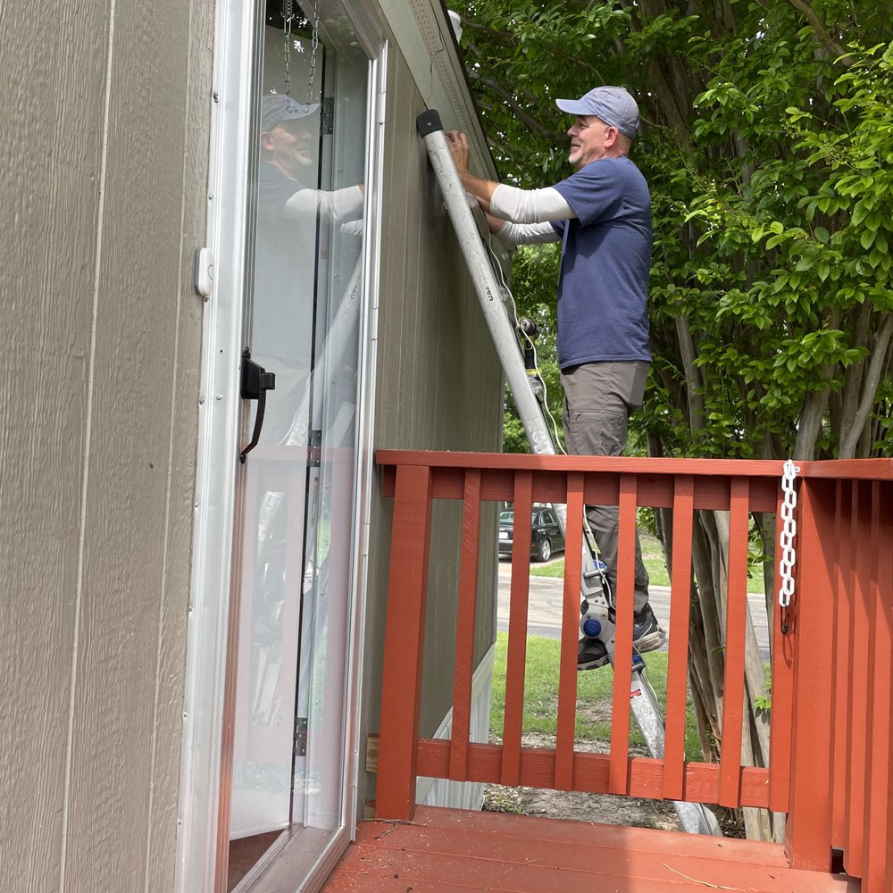 DVI - He is finishing the front door camera now, with a full view of the porch and everything behind it. - Security Systems Near Me