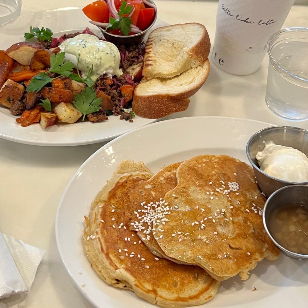 Tatte Bakery & Cafe | Assembly Row - Lamb Hash (top) and Greek Style Pancakes (bottom) - Breakfast & Brunch Near Me - Somerville, Massachusetts Tatte Bakery & Cafe | Assembly Row - Lamb Hash (top) and Greek Style Pancakes (bottom) - Breakfast & Brunch Near Me - Somerville, Massachusetts