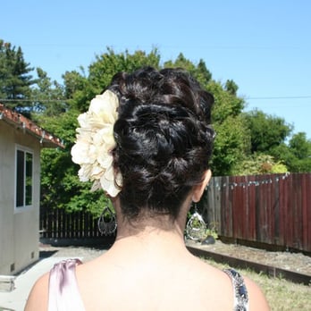 Transitions Salon - Up-do; messy bun with poof bangs topped off with a flower accessory! - Hair Salons Near Me - Pinole, California Transitions Salon - Up-do; messy bun with poof bangs topped off with a flower accessory! - Hair Salons Near Me - Pinole, California