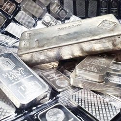 Scottsdale Bullion & Coin - Stacks of silver bullion bars and silver ingots.