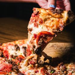 SKYBOKX 109 Sports Bar & Grill - The Heady Hitter-Chef's signature cheese blend, pepperoni, hamburger, bacon, tomato sauce