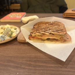 Turkey Panini with side plate of olives & avocado.