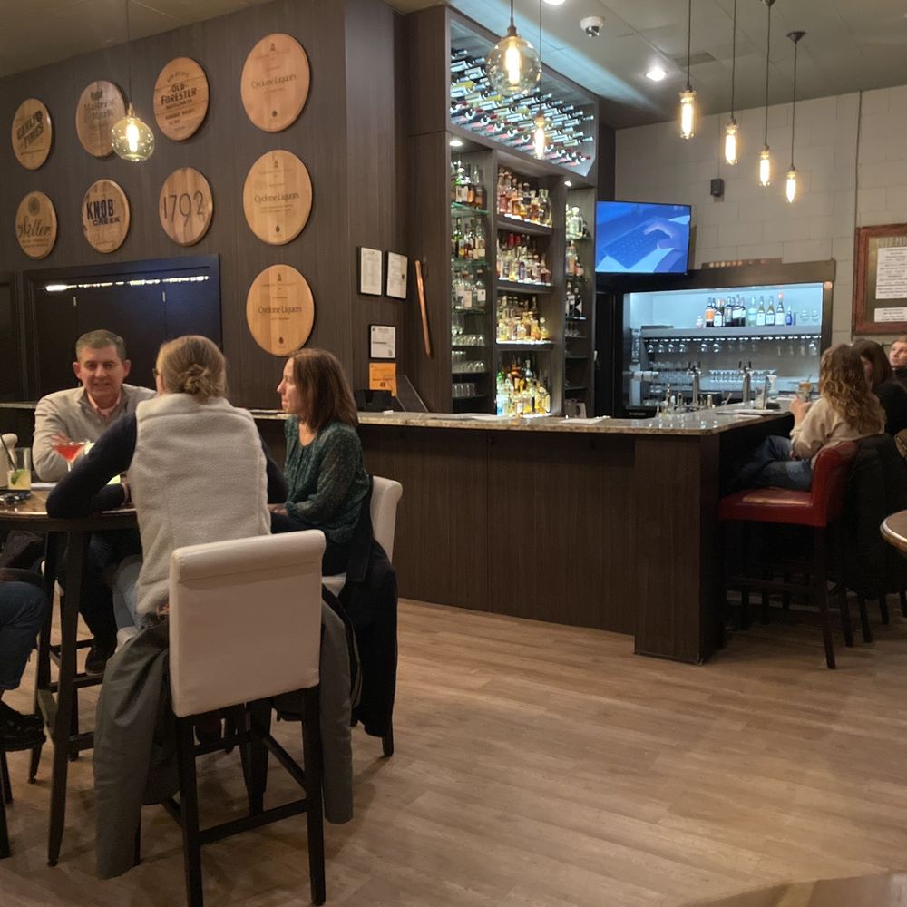 a group of people sitting at a bar a group of people sitting at a bar
